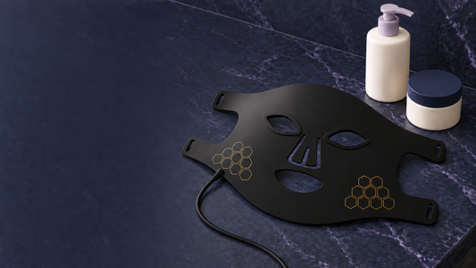 Tyxena LED light mask as part of a skincare routine, navy marble setting